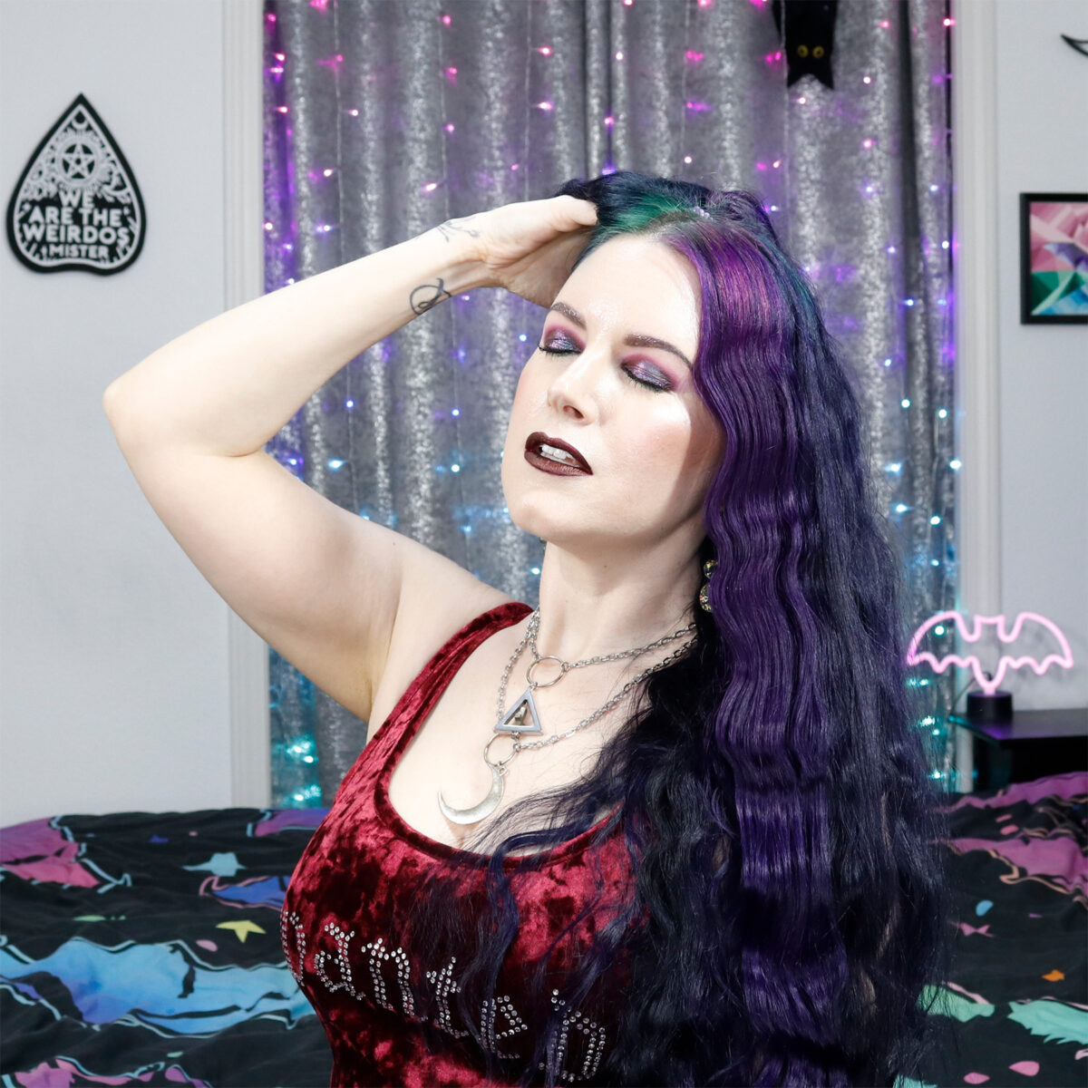 Cordelia has wavy purple and black colorblock hair