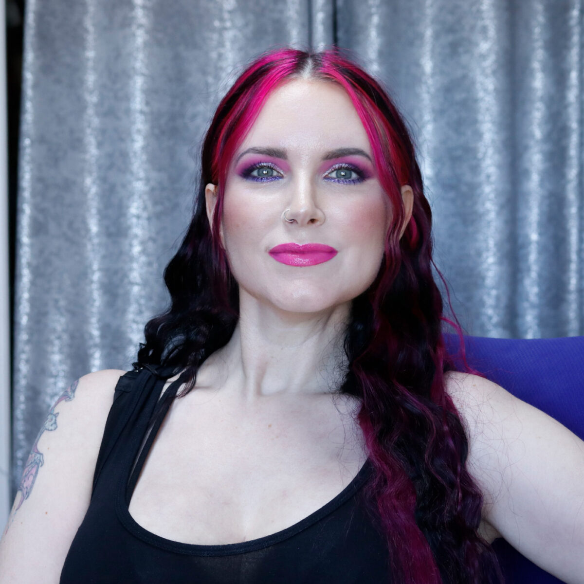 Cordelia is wearing bold pink makeup