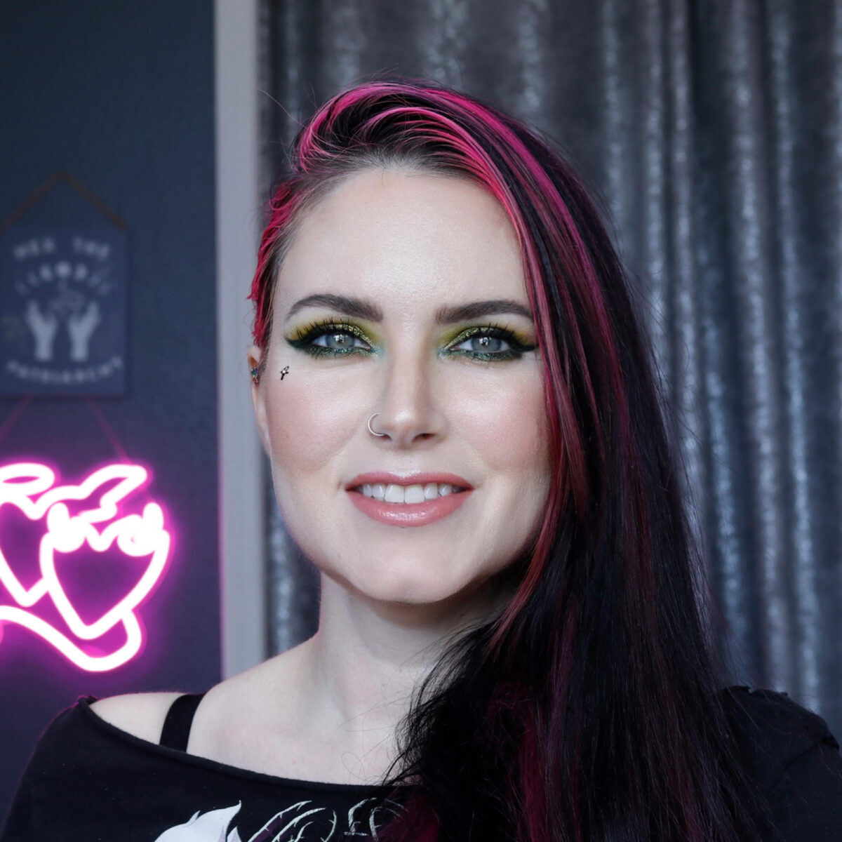 Cordelia has blue-green eyes and is wearing About Face Holographic Eye Paint in Luna