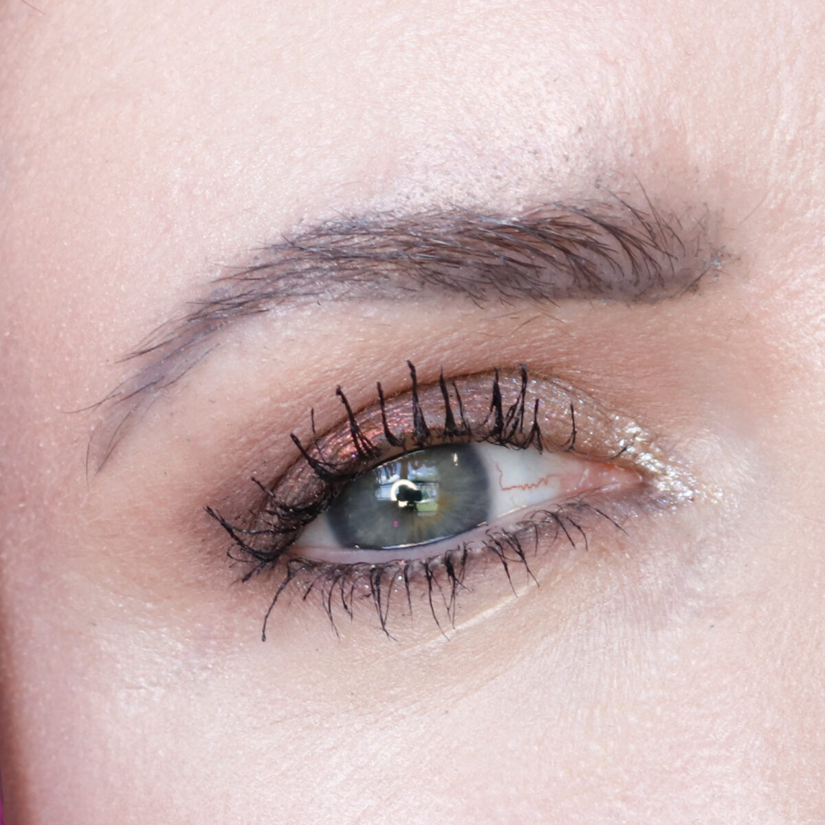 About Face Total Eclipse Eyeshadow diffused on top of beige eyeshadow